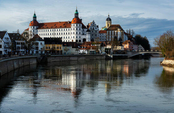 Neuburg an der Donau, Germany. Neuburg Castle, a residence of Dukes of Palatinate-Neuburg, reflected in Danube in sunny day. The Renaissance castle was built in 1530-1545