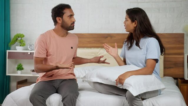 angry Indian couples arguing together at bedroom - concept of family problems, relationship conflict and disagreement