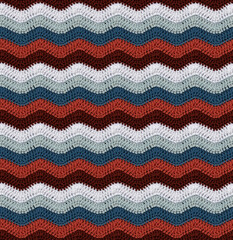 Seamless knitted pattern in the form of zigzags crocheted with threads of contrasting colors. Cotton yarn. African style.