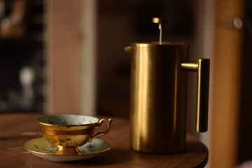golden teapot and cup