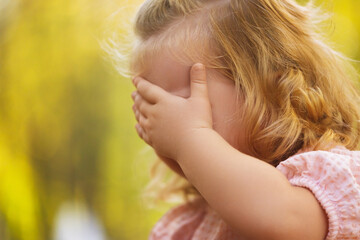 Child girl crying in the park. Selective focus. Kid. A little preschool-aged 3-5 year old girl is...