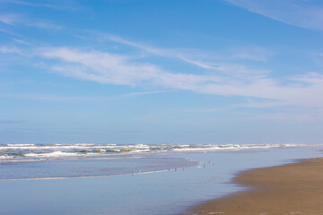 Landscape view of wide and long beach, White sand under blue sky and white puffy could, The Dutch Wadden Sea island Terschelling, A municipality and an island in the northern, Friesland, Netherlands.