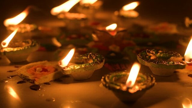 Clay diya lamps lit during diwali celebration.