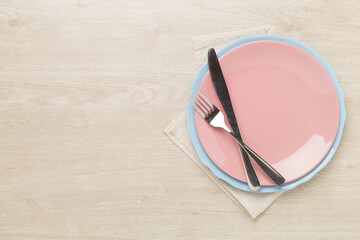 Minimal table setting on wooden background, top view