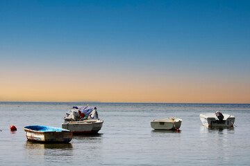 Fototapeta na wymiar Fishing boats on the sea and the incredible sky. 