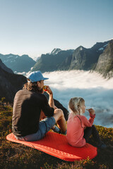 Family camping in mountains travel vacations father and daughter eating snacks outdoor dad with...