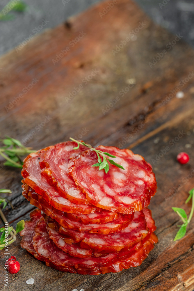 Wall mural salami sausage slices dry cured pork sausage chorizo on a wooden board