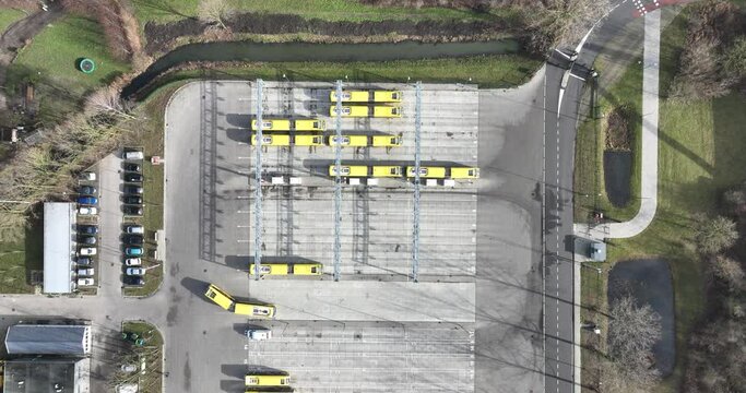Utrecht, The Netherlands, February 7th, 2024: Electric public transport busses in Utrecht, charging station, Modern sustainable clean transportation. Fossil free energy. Birds eye aerial drone view.