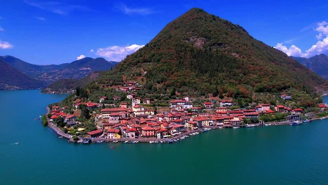 Italian lakes scenery. Iseo lake . Aerial drone view of beautiful Monte Isola island and Peschiera Maraglio village. Italy, Brescia province
