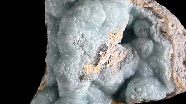 Green Hemimorphite or Calamine sample rotating slowly against a black background.	