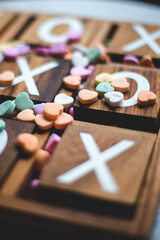 XOXO pattern on wooden blocks with heart shaped colorful candy