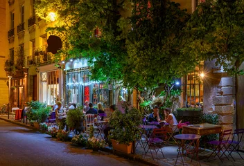 Deurstickers Cozy street with tables of cafe in Paris, France. Night cityscape of Paris. Architecture and landmarks of Paris. © Ekaterina Belova