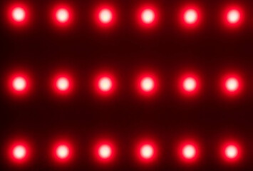 red blurred dots on black background, red light therapy