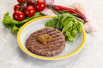 Frilled beef burger cutlet with iceberg