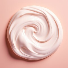 Swirling dollop of white cream creates a luxurious texture against a soft pink background, embodying the essence of skincare elegance