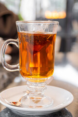 Glass with hot tea infusion