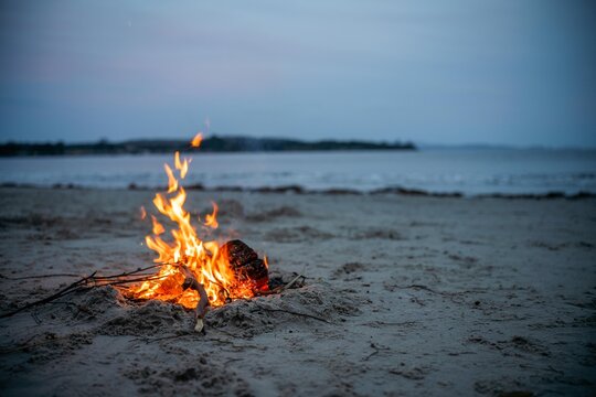 fire on the sand in australia. campfire on a beach in summer