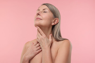 Beautiful woman with healthy skin on pink background