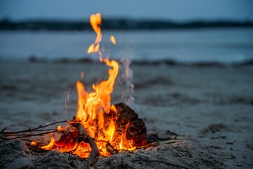 fire on the sand in australia. campfire on a beach in summer