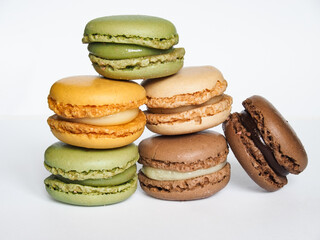 Tasty five french macarons isolated on white background.