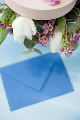 Blue envelope and box with bouquet