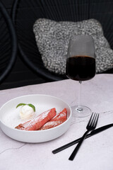 Plate with sweet pink pancakes and ice cream with coffee glass top view
