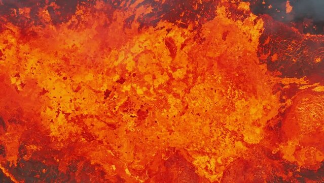 Close up view of active volcanic crater eruption. Hot lava and magma splashing out of crater. Tourist attraction in Iceland Litli-Hr&uacute;tur eruption 2023. Beautiful and dangerous disaster.