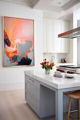 A kitchen with a serene, neutral palette enlivened by a single bright, abstract painting on the wall.