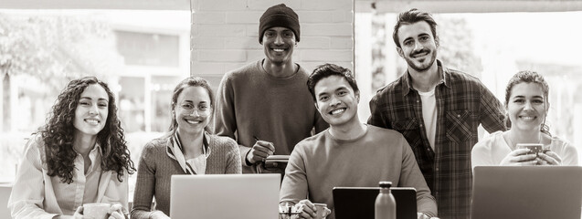 Horizontal banner or header with smiling multiethnic coworkers looking at camera making team...