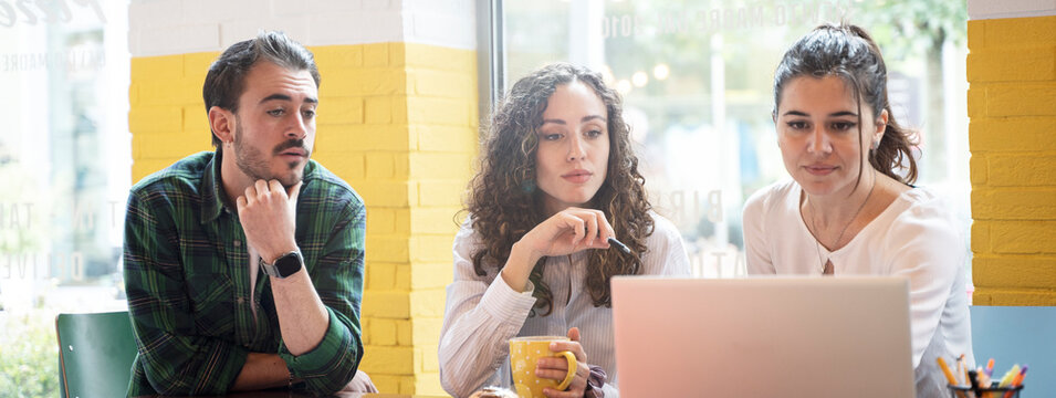 Horizontal banner or header with university students studying together on a new project in creative coworking classroom - Bright filter with focus on woman on center