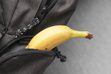 Banana in backpack. School lunch packed. Fruit healthy snack for kid. Banana in pocket.