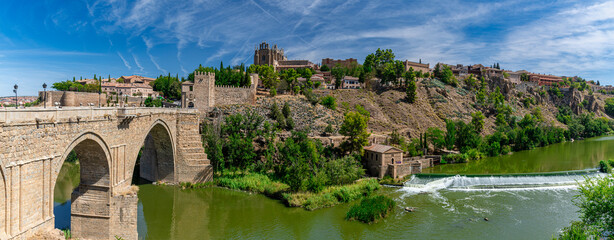 Panorama of the old historical city of Toledo with the bridge Puente de San Martín on the left and...