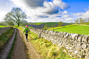 Hiker with pink hat, in Wetton, Staffordshire.