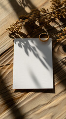 Wedding rings on a white sheet of paper on a wooden background