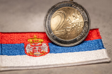 Serbian flag and 2 euro coin, Financial concept, Serbia's plans to join the euro zone, close up