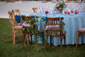 Bride and groom. Wedding bride and groom Signs on chairs standing in the woods.