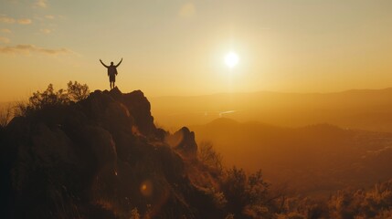 person alone on top of the mountain with arms up celebrating having achieved their goals