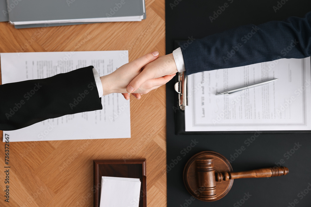 Canvas Prints Notary shaking hands with client at wooden table, top view