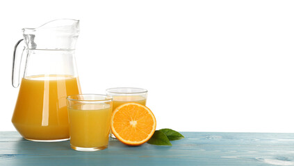 Delicious orange juice and fresh fruit on light blue wooden table against white background. Space for text