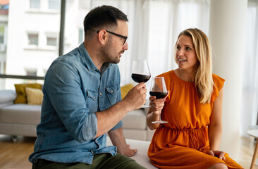 Happy couple having a romantic date and drinking wine. Couple love romance concept.