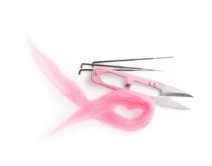 Pink felting wool, scissors and needles isolated on white, top view