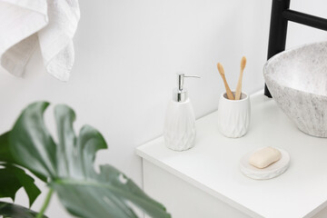 Different bath accessories and personal care products in bathroom