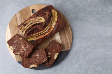 Delicious banana bread on grey table, top view. Space for text