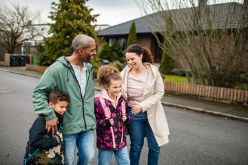 Parents walking kids to school outside