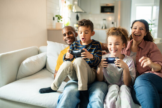 Family playing video games together in living room