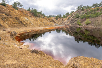 Red view of Sia Mine Red Lake, a former copper and pyrite mine excavation basin filled with water,  forming an impressive location, located near Sia Village, Nicosia district, Cyprus