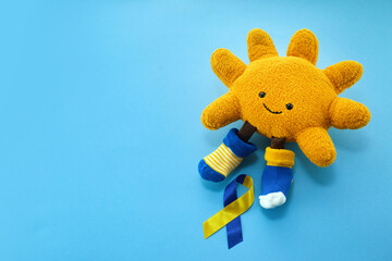 Down Syndrome Awareness day. Symbolic sun, two color ribbon