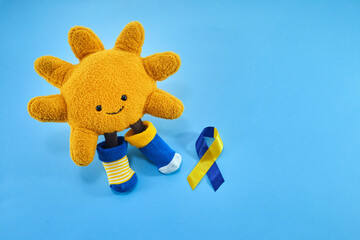 Down Syndrome Awareness day. Symbolic sun, two color ribbon
