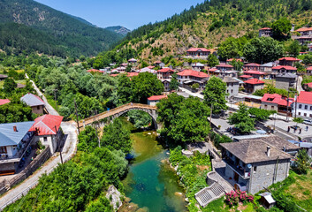 Aerial view of the old stone bridge over Aoos river at Vovoussa village, Zagori region, Ioannina, Epirus, Greece.