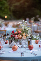 Set table at a wedding reception with floral centerpiece and candles
